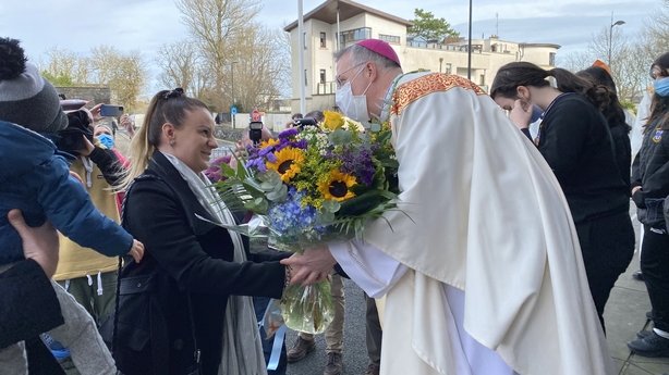 Bishop Michael Duignan receiving flowers